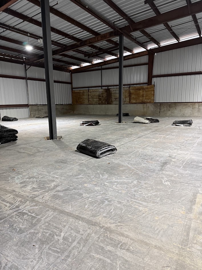 Finished concrete slab floor inside a steel-framed building