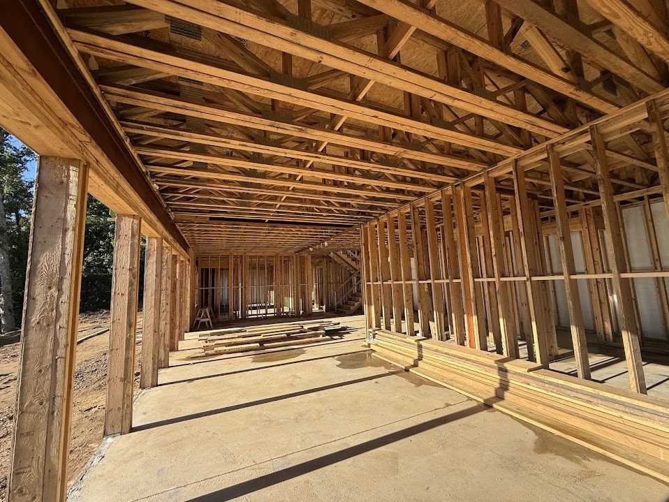 Interior wood framing with engineered floor trusses and plywood subfloor