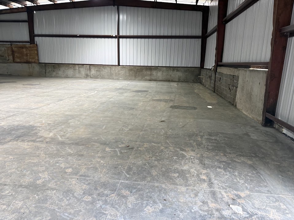 Finished concrete floor beside a concrete block foundation wall
